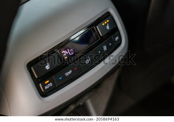 Car air conditioning buttons close up view\
inside a car. Car temperature conditioner dashboard panel. Adjust\
air conditioner.