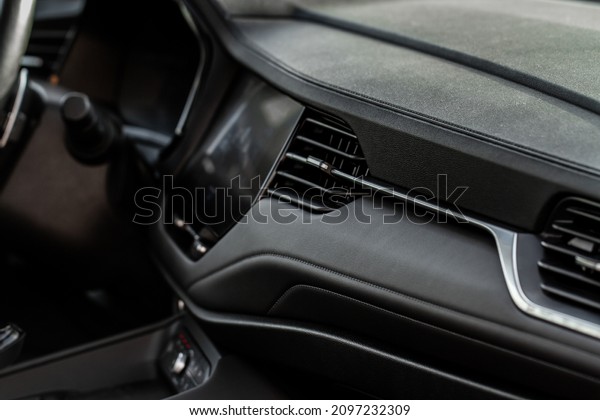 Car air\
conditioning close up view. The air conditioner flow inside the\
car. Detail interior of car. Air\
ducts.