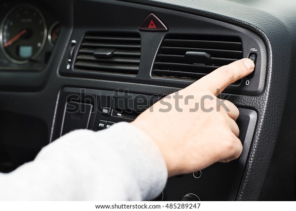 Car air\
conditioning system grid panel on console, Man using automobile Air\
deflector, Car climate control, A man sliding air conditioner\
switch in automobile, air\
ventilation