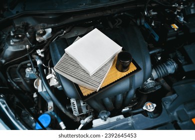 Car air filter and car oil filter on engine cover in engine compartment , Car spare parts concept - Powered by Shutterstock