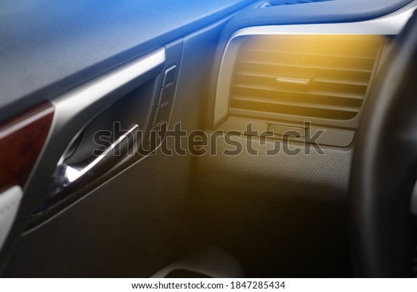 Car air heating concept. Hot air from the vent panel\
grille of a modern car.