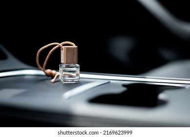 Car air perfume freshener bottle inside the car on car panel. Aromatic liquid in the small bottle. - Shutterstock ID 2169623999