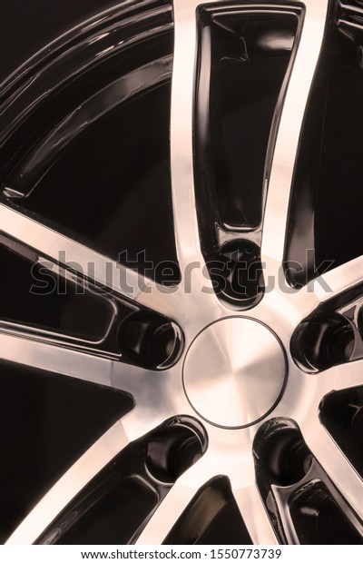 car alloy wheel black and white
spokes on black background, element close up
vertically