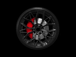 Car Alloy Wheel And Tyre Isolated On Black Background. New Alloy Wheel With Tire And Yellow Carbon Ceramic Brakes. Alloy Rim Isolated. Car Wheel Disc. Car Spare Parts.
