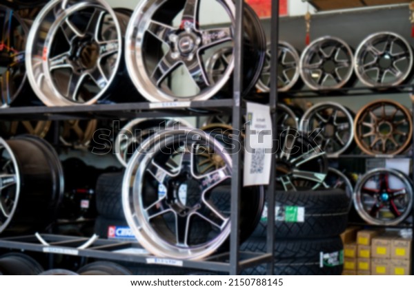 Car alloy wheels are placed on the floor. In the\
warehouse. Blur the\
focus.\
