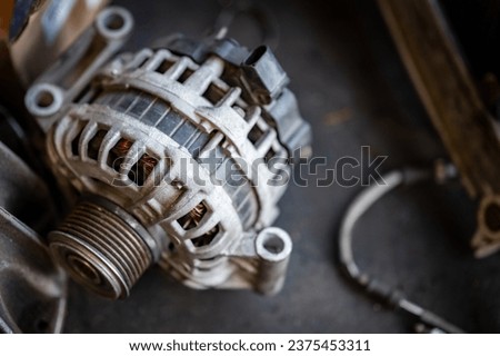 Car alternator or car starter dynamo part. Auto repair and maintenance service in the garage. Mechanical engineering and automotive industry