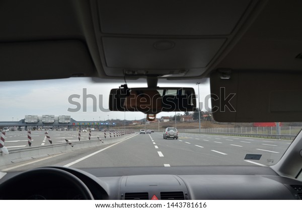 Car approaching a pay\
toll on a highway