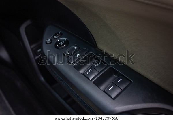 Car arm rest with Control Panel. Door Lock &\
Mirror Control. window adjustment buttons, door lock. Photography\
of a modern car.