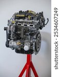 Car assembly tools and dismantled car engine in a car mechanic workshop