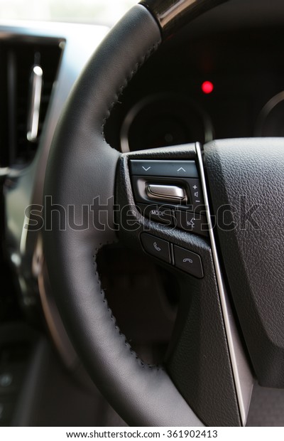 Car audio control buttons on a steering wheel in\
modern car