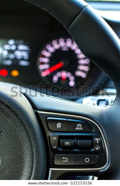 Car audio control buttons on steering wheel.\
Selective focus.