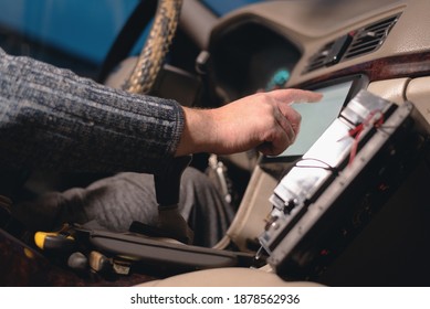 Car Audio Engineer Is Adjusting A Car Stereo System Close Up.