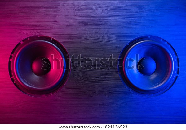 A\
car audio loudspeaker on the table in the neon\
lights.