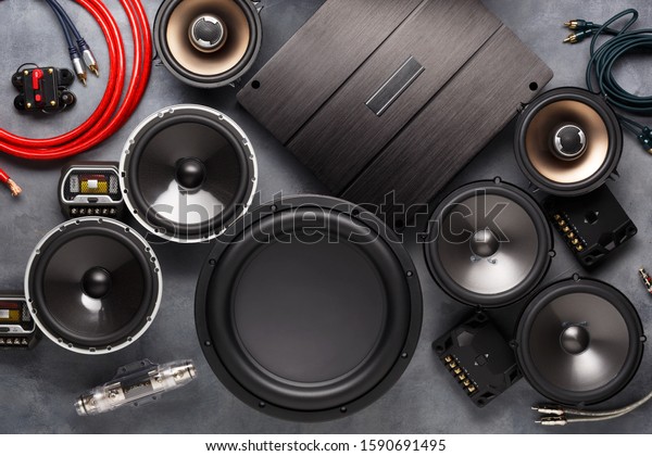 car audio, car speakers, subwoofer\
and accessories for tuning. Dark background. Top\
view.