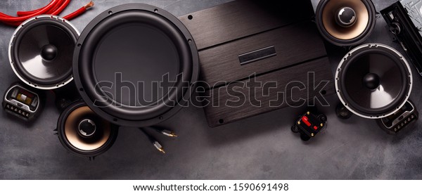 car audio, car speakers, subwoofer\
and accessories for tuning. Dark background. Top\
view.