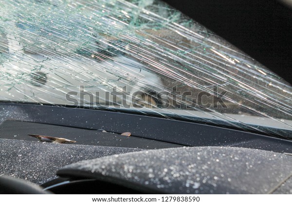 Car / Auto crash; Smashed windscreen from
interior of vehicle.