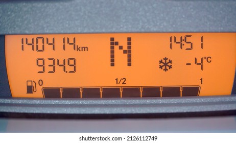 Car Automobile Dashboard LED Orange Display. High Vehicle Mileage, N Neutral Shift Gear, Full Tank Of Gasoline, Cold Icy Road In Winter Warning.