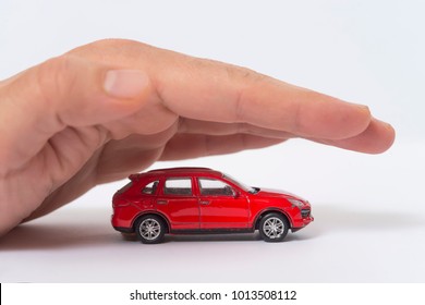 Car (automobile) insurance and collision damage waiver concepts. Businessman with protective gesture - Powered by Shutterstock