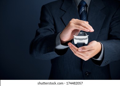 Car (automobile) insurance and collision damage waiver concepts. Businessman with protective gesture and icon of car.  - Powered by Shutterstock