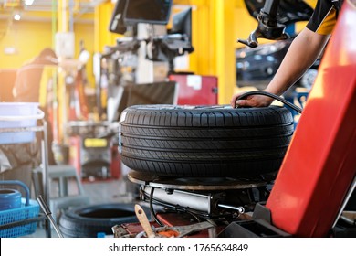 Car Automobile Mechanic Working On Repairing The Wheel Tire Of Vehicle, Taking Car In For Service Workshop For Male Car Mechanic Fixing Problems Replacing Broken Parts Of Using Tools And Equipment