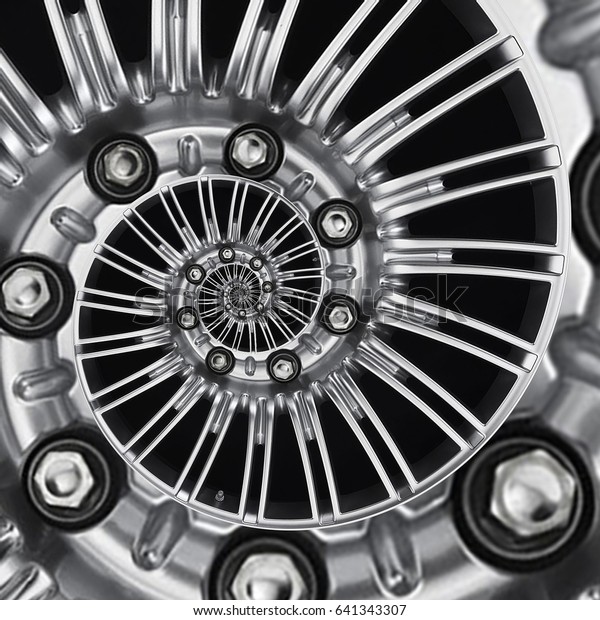 Car automobile wheel rim spiral abstract metallic\
fractal background. Silver hex nuts, wheel spokes spiral effect\
pattern background illustration. Automotive abstract wheel. Truck\
chrome wheel rim