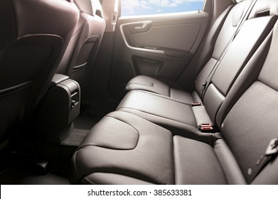 Car Backseats With Sun Light Flare And Blue Sky In The Side Windows