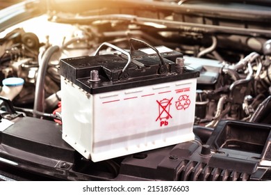 The car battery of the automobile electrical system in the engine compartment for car maintenance and recycle electronics garbage , Car maintenance service concept