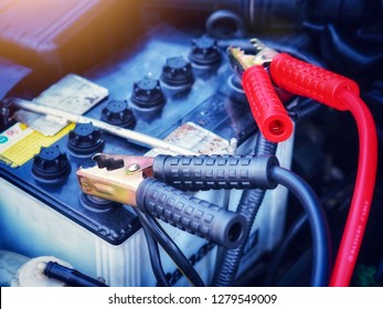 Car Battery, Electric Vehicle Battery Charger Via Jumper Cable.