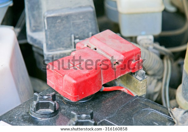 Car battery with red positive\
polarity for auto concept (Selective focus at positive\
symbol)