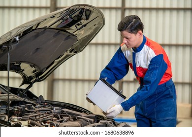 Car Battery Repairman,Male Mechanic Changing Car Battery.