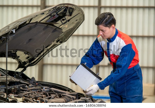 Car\
battery repairman,Male mechanic changing car\
battery.