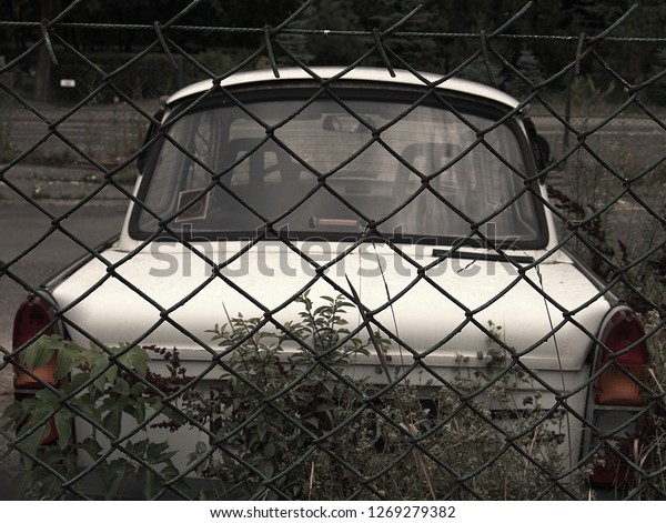 Car behind\
fence