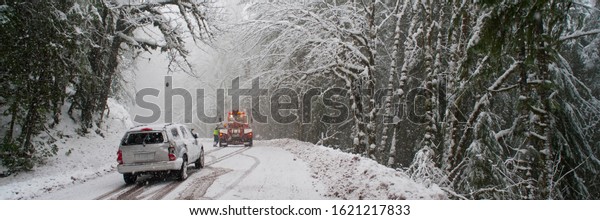 Car being towed
after accident in snow
storm