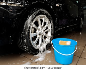 Car Is Being Washed At House. After Washed By Sponge And Soap, Suface Of Car Is Partially Covered With Bubbles. Cleaning Car At Home. Activity At Home During Weekend. 