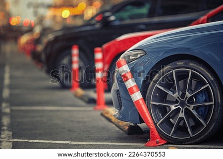 Car bent polyurethane flexible post while parking on crowded parking lot in downtown. Car damaged flexible bollard on parking stalls. Car hit bollard at parking lot, damaged driver side bumper