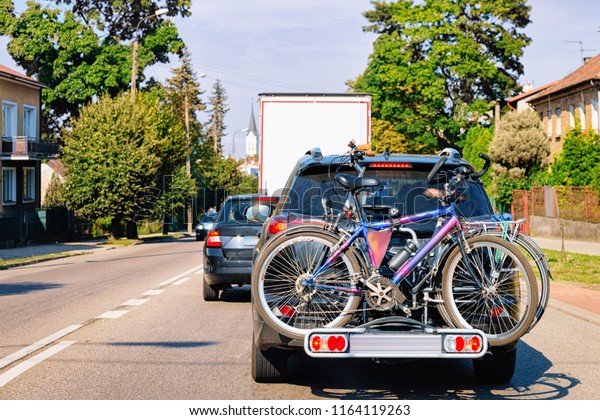 Car with bicycles on\
the road in Poland.
