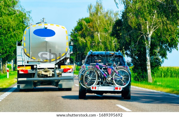 Car with bicycles in\
the road in Poland.