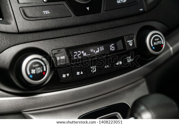 Сlose-up of the car \
black interior:  dashboard, adjustment of the blower, air\
conditioner and other buttons.\
