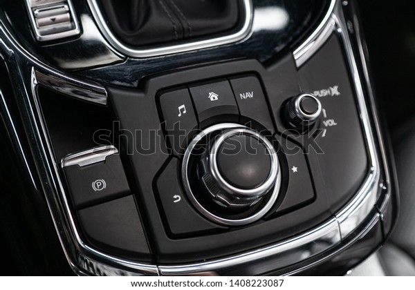 Сlose-up of the car  black\
interior:  dashboard,  navigator, menu, music, parking and other\
buttons
