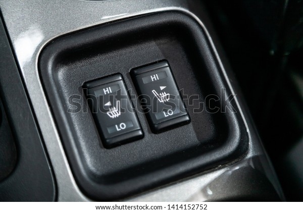 Сlose-up of the car  black interior:  seat\
heating buttons