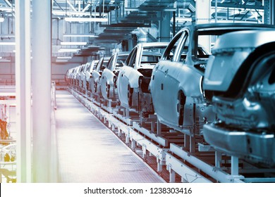 Car bodies are on Assembly line. Factory for production of cars in blue. Modern automotive industry. Blue tone