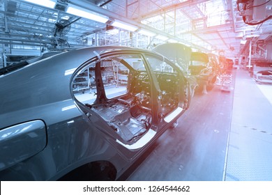 Car Bodies Are On Assembly Line. Factory For Production Of Cars In Blue. Modern Automotive Industry. Blue Tone