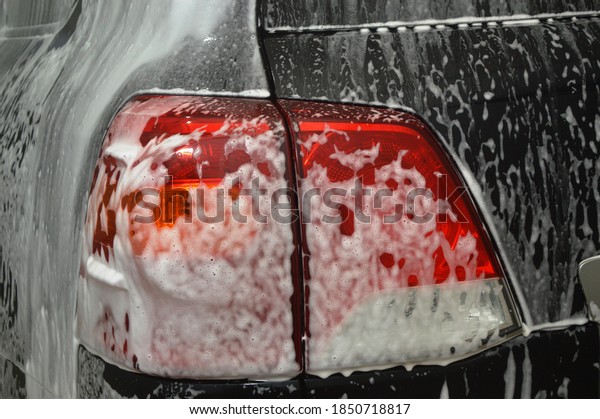 Car body is covered with soap foam to remove dirt\
from the body
