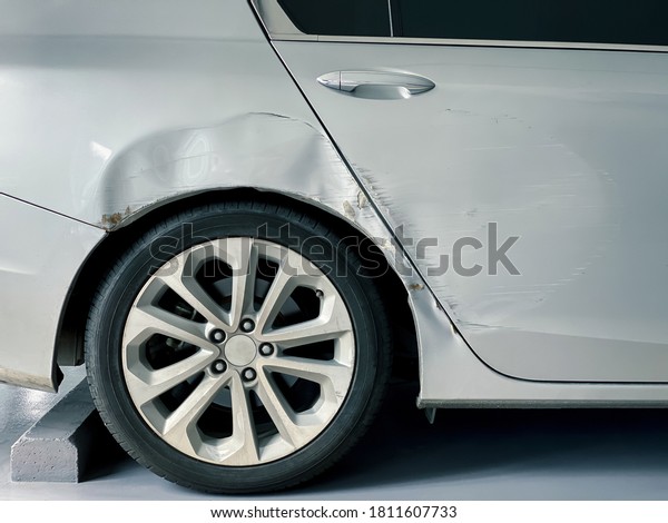 car body damage after accident, scratch and\
dent on body of modern car at car\
park