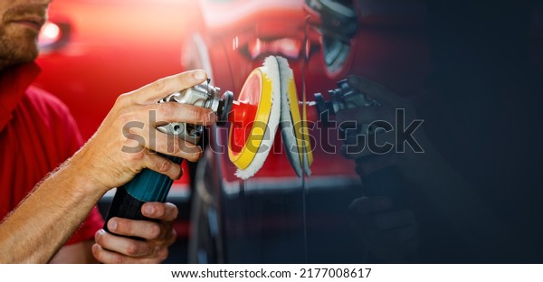 car body repair and detailing workshop. man\
polishing vehicle paint. copy\
space