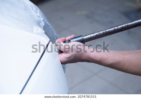 Car body\
repair. Preparation for painting car\
parts.