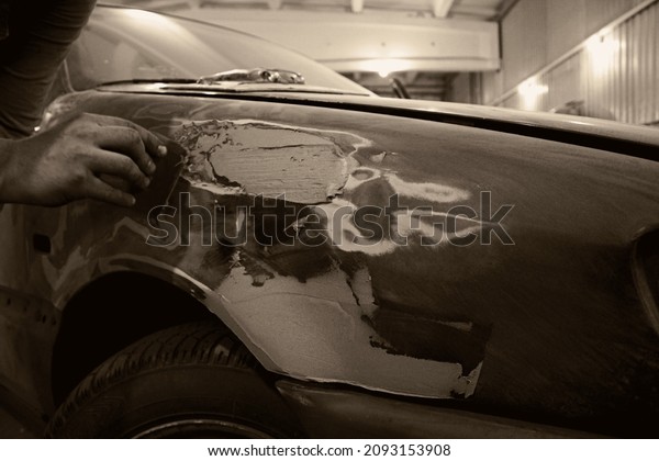 Car body restoration with bokeh effect, front and\
background blurred