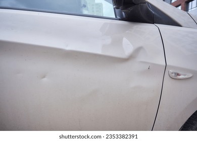 Car body side damage, traffic accident in winter season. Car door damage, broken and damaged side mirror on car door