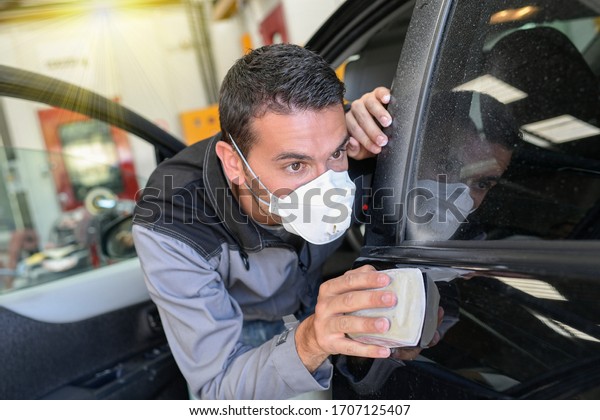 Car body\
worker polishes the car before his\
delevery