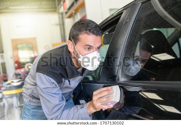 Car body\
worker polishes the car before his\
delevery